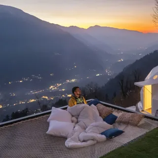 Glamping dome on a cliff at twilight