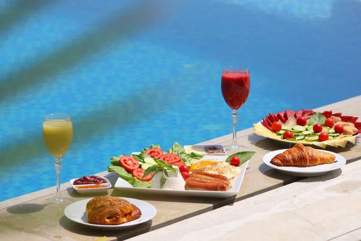 Curated breakfast spread beside a pool