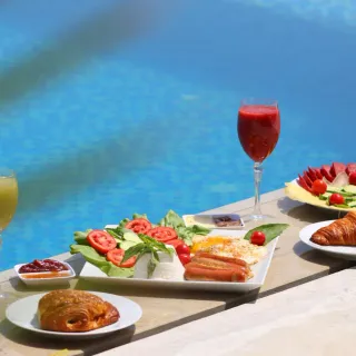 Curated breakfast spread beside a pool