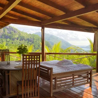 Open wooden pavilion in a jungle setting