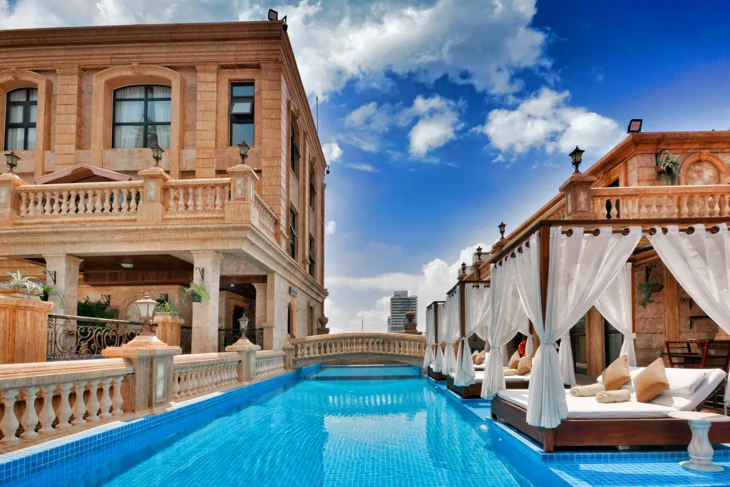 Grand hotel exterior with twin poolside cabanas