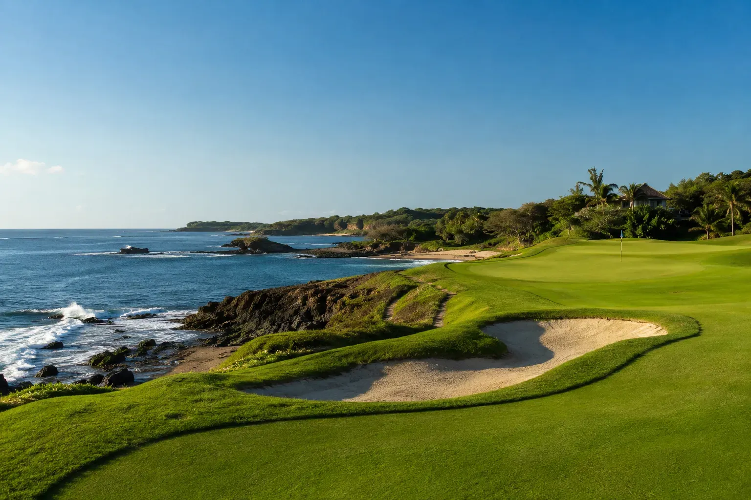Coastal golf course green beside the sea at golden hour
