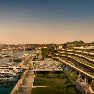 Aerial of Grand Park Hotel Rovinj cascading down to the marina, with Rovinj old town in the distance