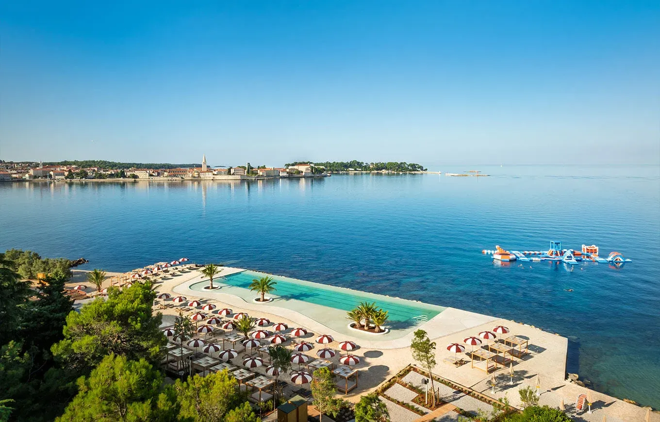 Aerial view of the infinity pool by the sea at Valamar Pical Resort