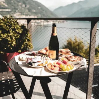 Champagne and canapes on a terrace over Lake Como