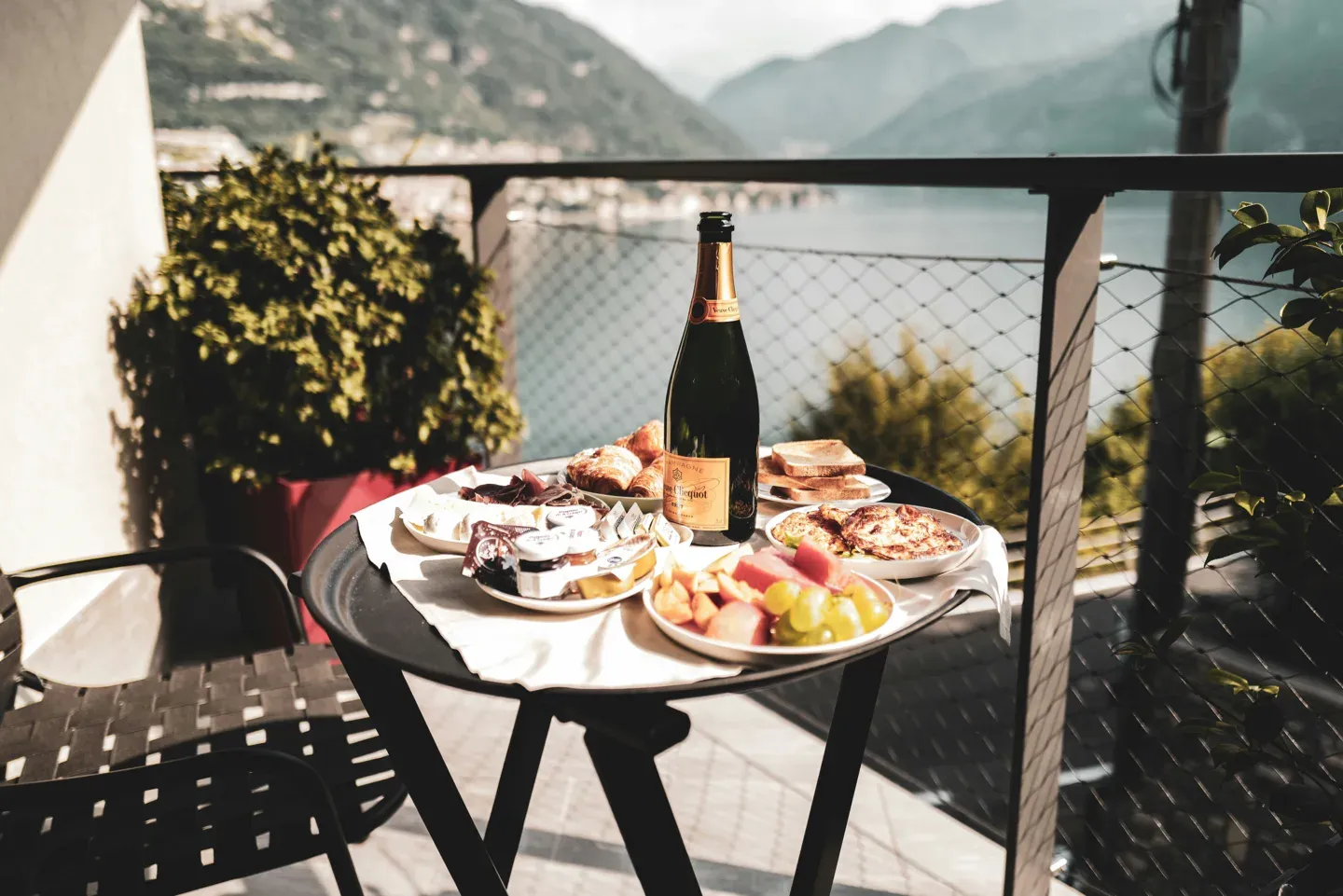 Champagne and canapes on a terrace over Lake Como