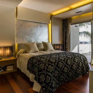 Theatrical hotel bedroom with patterned bedspread