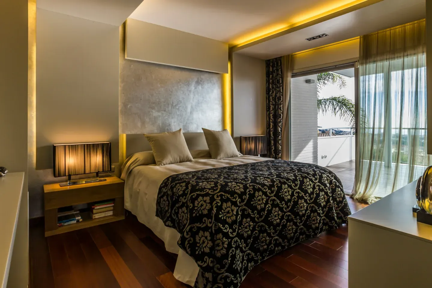 Theatrical hotel bedroom with patterned bedspread