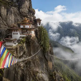 Cliffside Himalayan monastery draped in prayer flags