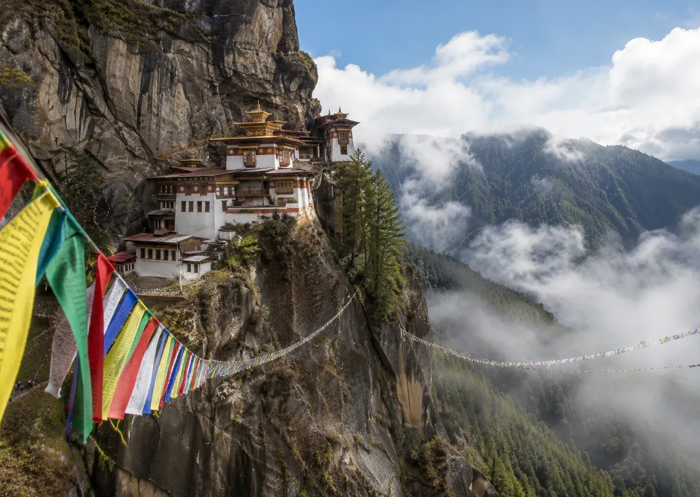 Cliffside Himalayan monastery draped in prayer flags