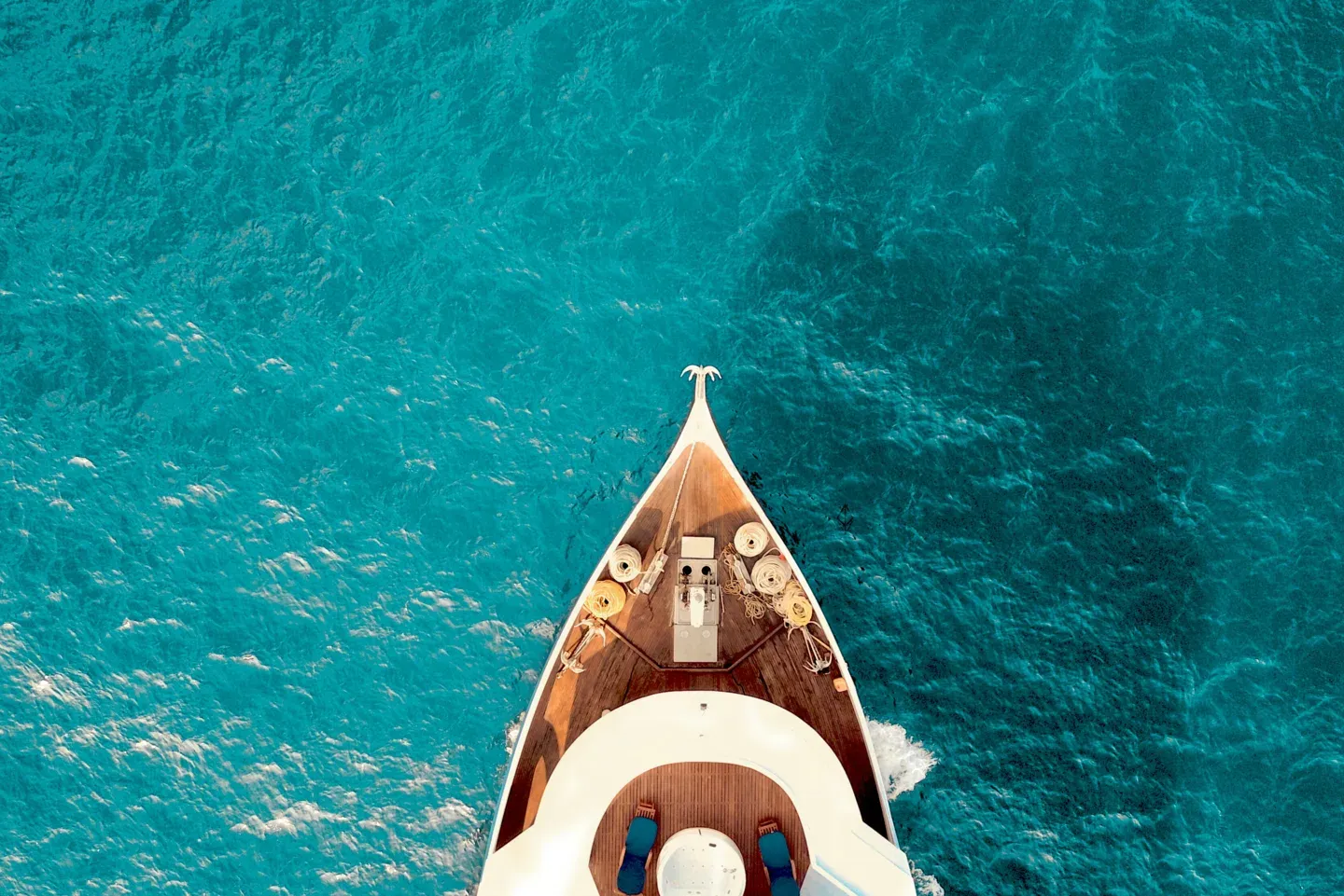 Yacht bow cutting through open ocean