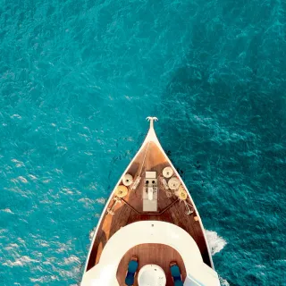 Yacht bow cutting through open ocean