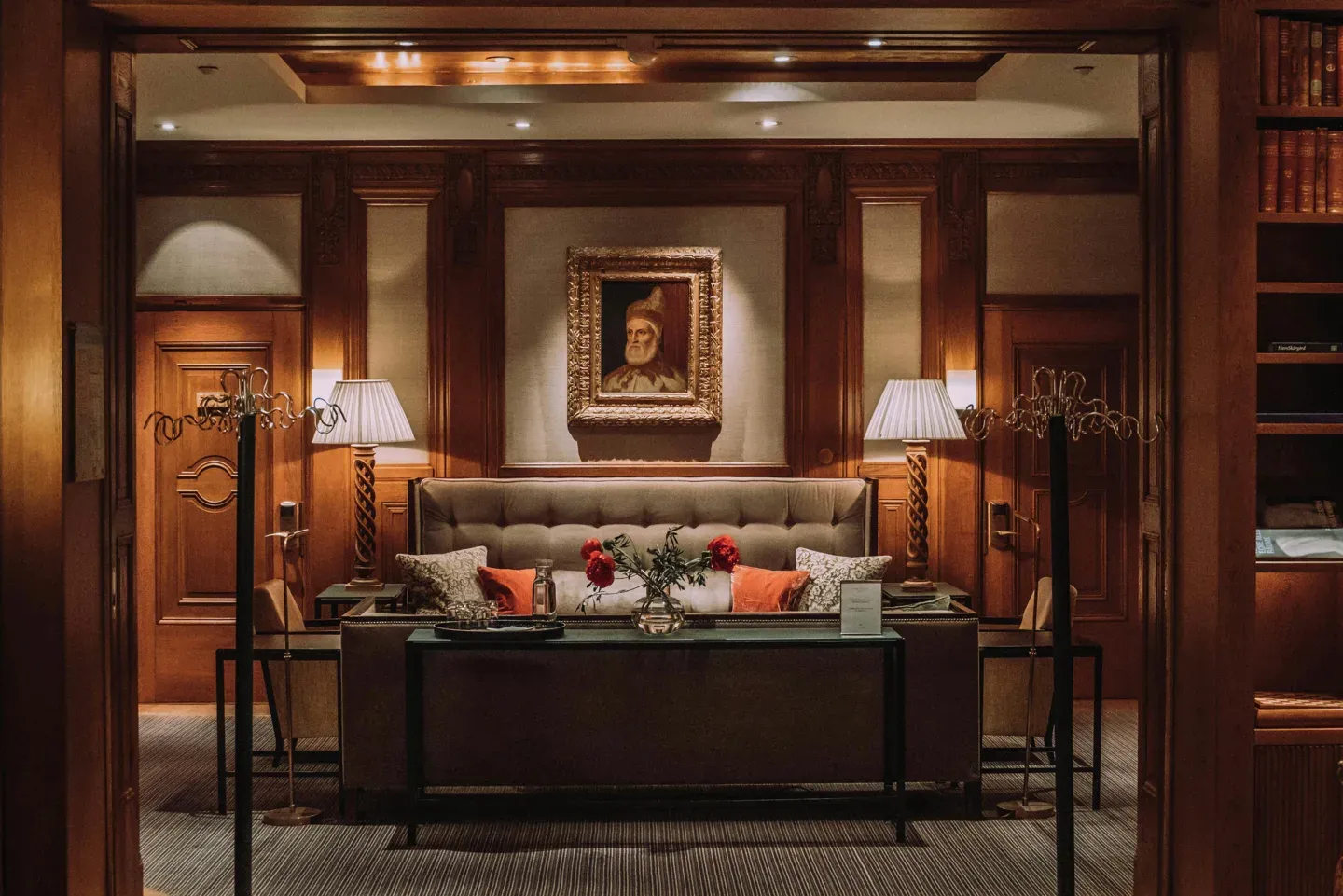 Wood-panelled library lounge with a framed portrait