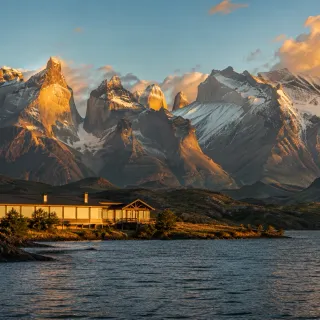 Patagonian lodge beneath the Torres del Paine massif at sunset