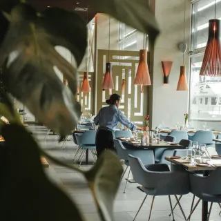 Restaurant staff setting marina-side tables