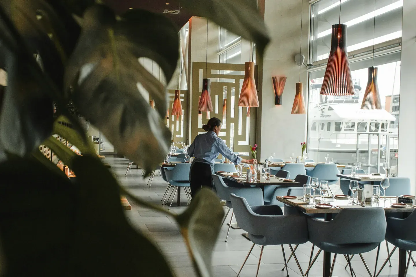 Restaurant staff setting marina-side tables